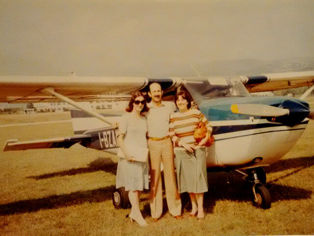 My dad standing in front of a Cessna